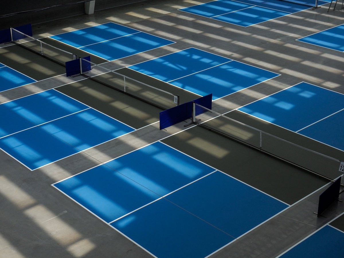 Pickleball court indoor with blue service area